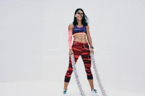Athletic woman doing fitness training using battle ropes